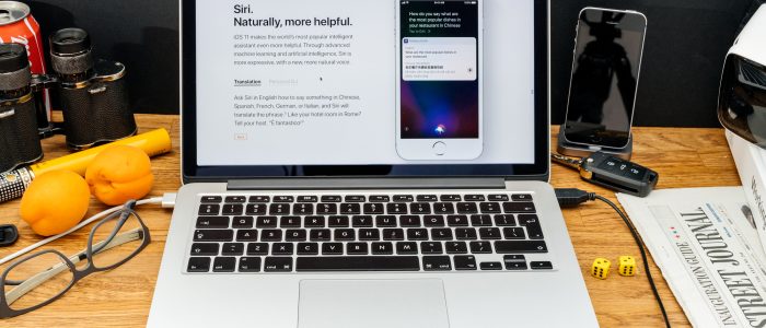 Zwei Apple-Systeme in einem Bild vereint: MacBook mit macOS und iPhone mit iOS