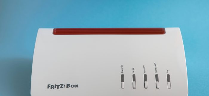 Eine FRITZ!Box 7590 vor einem blauen Hintergrund