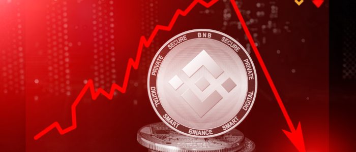 Ein Krypto-Coin mit Binance-Logo und fallendem Kurs im Hintergrund