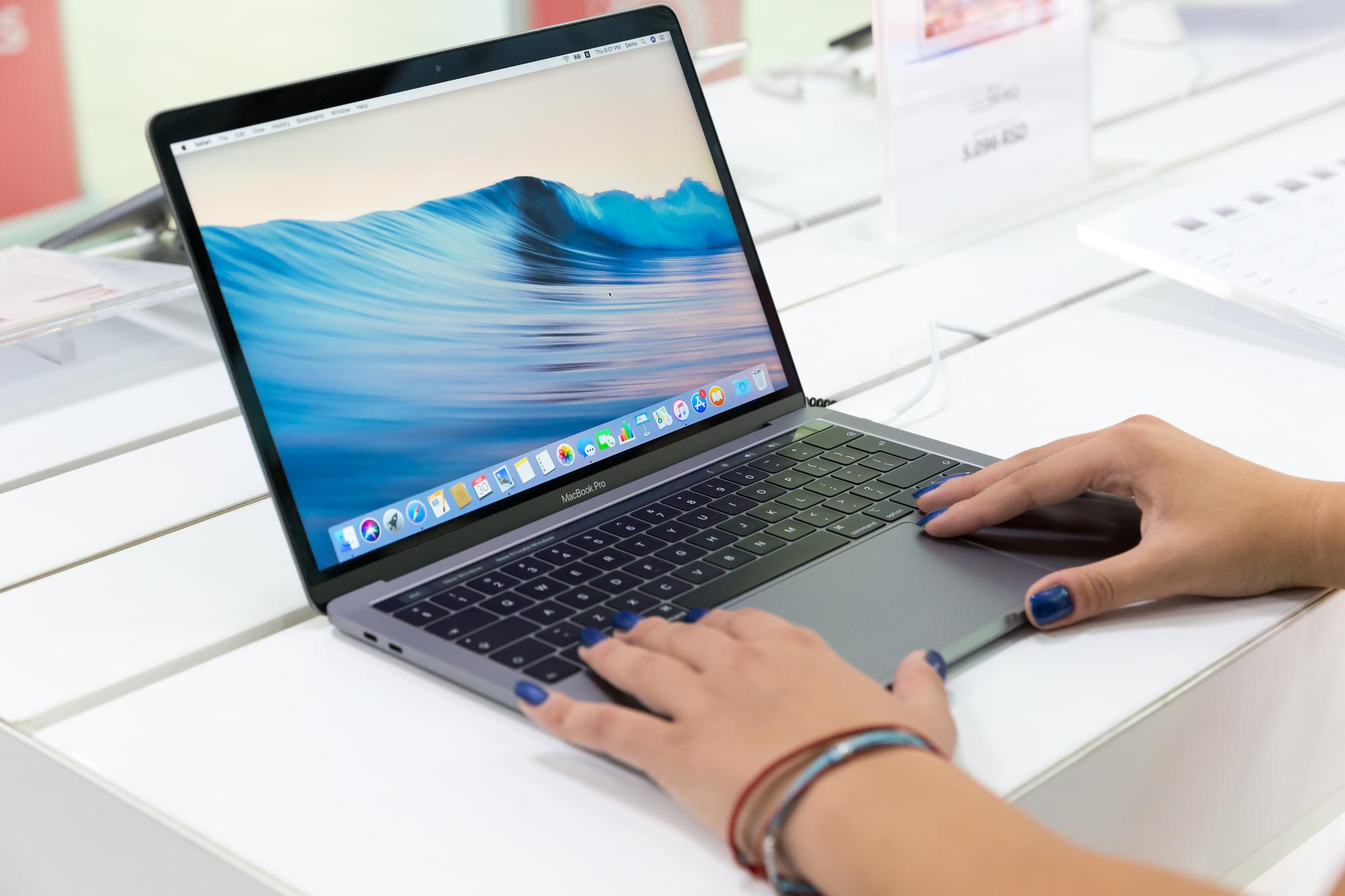 Zwei Hände auf einem Macbook mit macOS